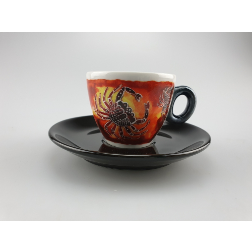 Selva Antica espresso cup in vibrant red with ethnic patterns and a crab, fine porcelain, shown with a stylish saucer.