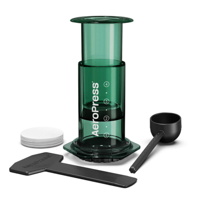 AeroPress Coffee Maker - Clear Green, shown with all included accessories such as scoop and paper filters.