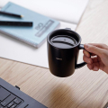 Hario heat retention mug with lid 300 ml black on desk next to laptop