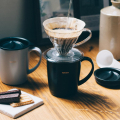 Hario heat retention mug 300 ml black with V60 glass dripper during brewing