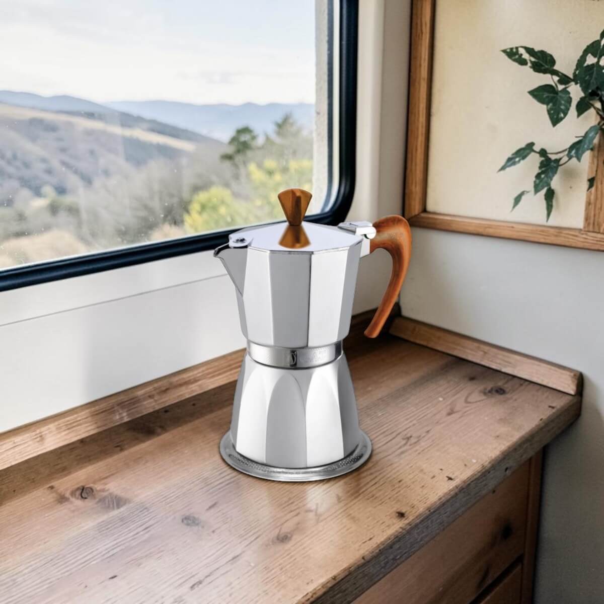 Espressokocher auf der Fensterbank im Wohnmobil – italienischer Espresso vom Gasherd oder Campingkocher, mit Blick in die Natur.