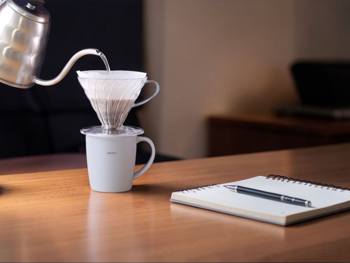 Hario heat retention mug with lid 300 ml grey with glass manual dripper during coffee brewing on desk